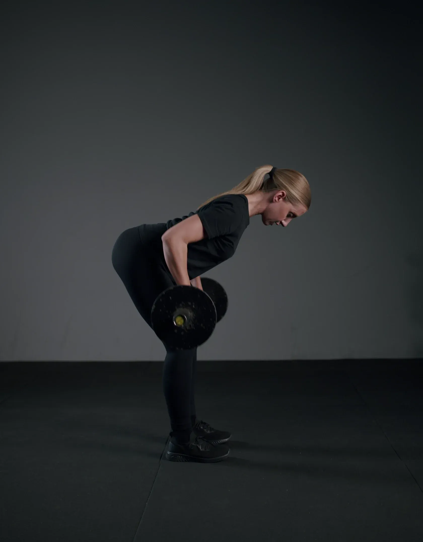 Athlete rowing a barbell, filmed for the Mentor exercise library