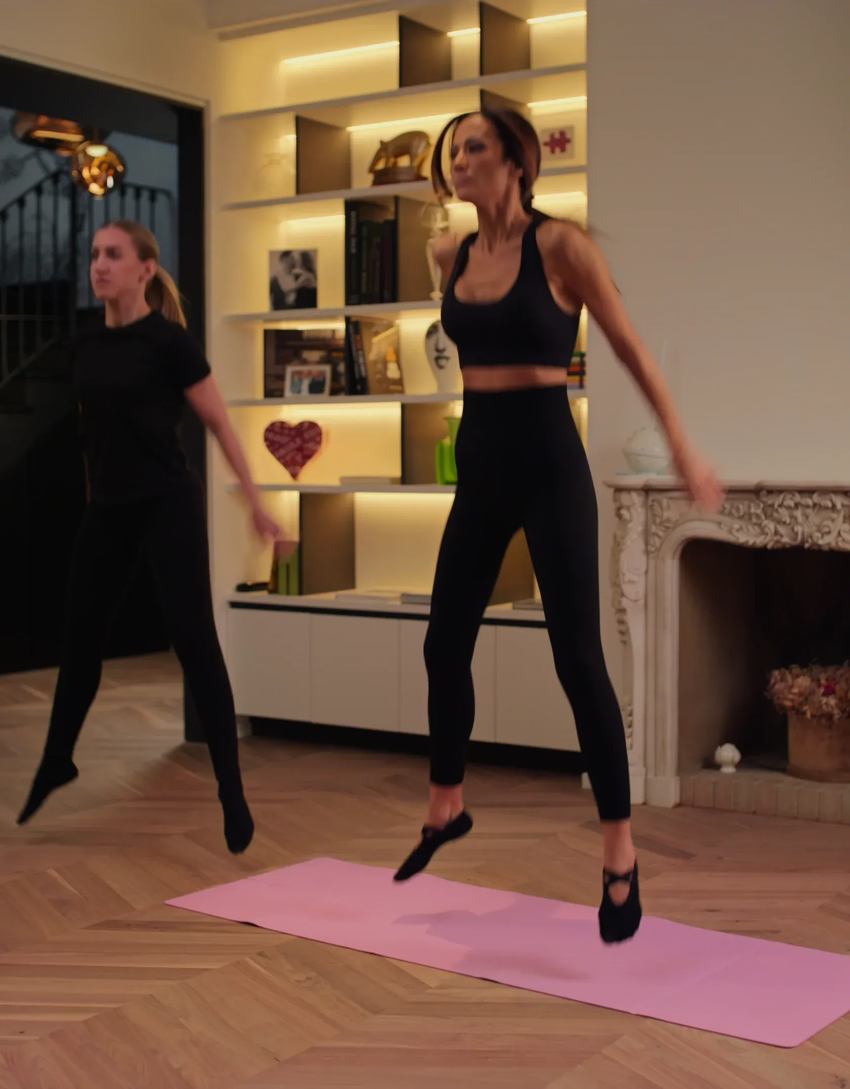 Athlete mid-air in a squat jump during a home workout